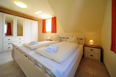 Ein Bett oder Betten in einem Zimmer der Unterkunft Hus Utblick 8A