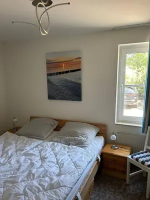 Ein Bett oder Betten in einem Zimmer der Unterkunft Sünnenkringel 36