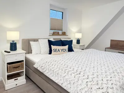 Ein Bett oder Betten in einem Zimmer der Unterkunft Dünenläufer Whg 6
