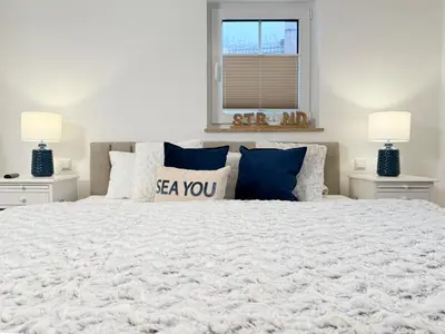 Ein Bett oder Betten in einem Zimmer der Unterkunft Dünenläufer Whg 6