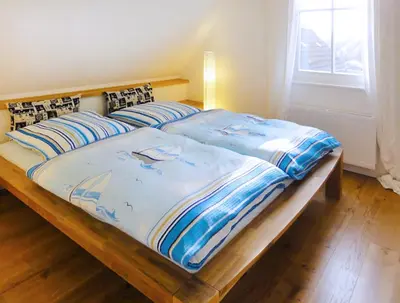 Ein Bett oder Betten in einem Zimmer der Unterkunft Wiecker Landhus FHH 2