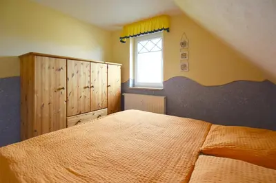 Ein Bett oder Betten in einem Zimmer der Unterkunft Strandläufer