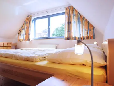 Ein Bett oder Betten in einem Zimmer der Unterkunft Haus Kormoran Wo 5