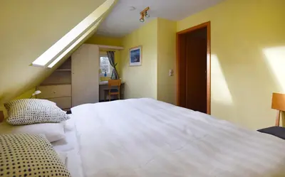 Ein Bett oder Betten in einem Zimmer der Unterkunft Muschelsucher Haus II 4
