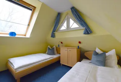 Ein Bett oder Betten in einem Zimmer der Unterkunft Muschelsucher Haus II 4