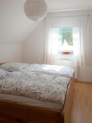 Ein Bett oder Betten in einem Zimmer der Unterkunft Haus Kormoran Wo 4