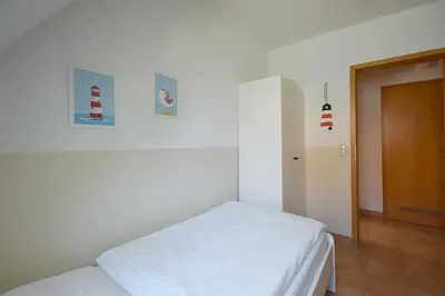 Ein Bett oder Betten in einem Zimmer der Unterkunft Haus Albatros Albatros Wo 3