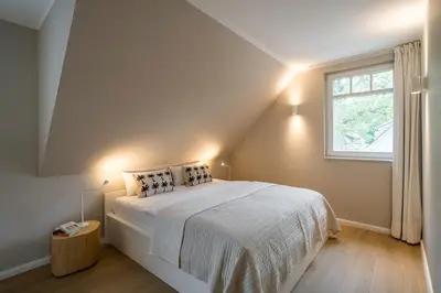 Ein Bett oder Betten in einem Zimmer der Unterkunft SEEHAUS Prerow