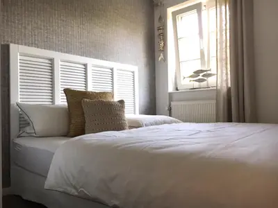 Ein Bett oder Betten in einem Zimmer der Unterkunft Achtern Diek Haus 6 Wohnung 2