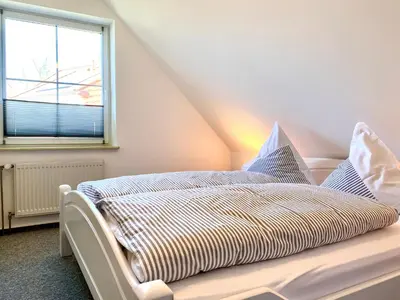 Ein Bett oder Betten in einem Zimmer der Unterkunft Hägerende 66 Haus Windrose Wohnung Südwind