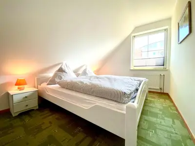 Ein Bett oder Betten in einem Zimmer der Unterkunft Hägerende 66 Haus Windrose Wohnung Ostwind