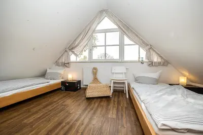 Ein Bett oder Betten in einem Zimmer der Unterkunft Rosenberg 24 Haus Deichrose