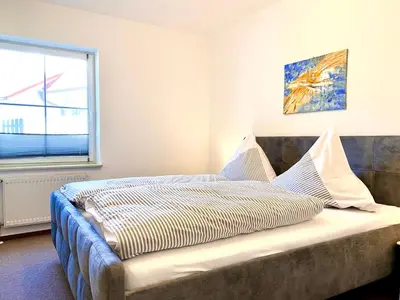 Ein Bett oder Betten in einem Zimmer der Unterkunft Hägerende 66 Haus Windrose Wohnung Westwind