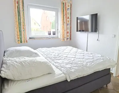 Ein Bett oder Betten in einem Zimmer der Unterkunft Zur Wellenwiese 22 Wohnung Sanderling