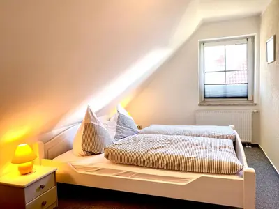 Ein Bett oder Betten in einem Zimmer der Unterkunft Hägerende 66a Haus Ankerplatz Wohnung Oberdeck