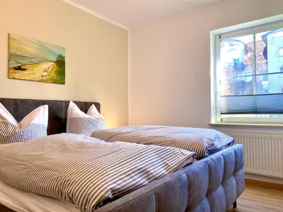 Ein Bett oder Betten in einem Zimmer der Unterkunft Hägerende 66 Haus Windrose Wohnung Nordwind