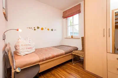 Ein Bett oder Betten in einem Zimmer der Unterkunft Dünengarten Am Bahndamm 77d Haus Seemuschel