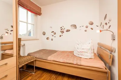 Ein Bett oder Betten in einem Zimmer der Unterkunft Dünengarten Am Bahndamm 77d Haus Seemuschel