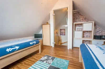 Ein Bett oder Betten in einem Zimmer der Unterkunft Dünengarten Am Bahndamm 77d Haus Seemuschel