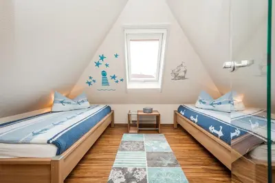 Ein Bett oder Betten in einem Zimmer der Unterkunft Dünengarten Am Bahndamm 77e Haus Seerose