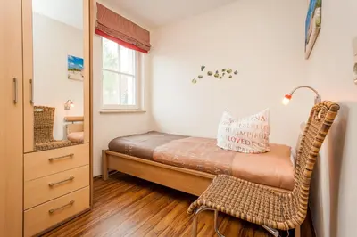 Ein Bett oder Betten in einem Zimmer der Unterkunft Dünengarten Am Bahndamm 77e Haus Seerose