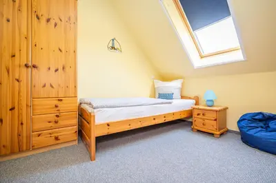 Ein Bett oder Betten in einem Zimmer der Unterkunft Neue Reihe 17 Wohnung Leuchtturm