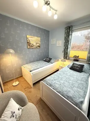 Ein Bett oder Betten in einem Zimmer der Unterkunft Wiesenstr 4 Haus Blaumöwe