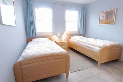 Ein Bett oder Betten in einem Zimmer der Unterkunft Strandstrasse 54a b Wohnung 3