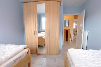 Ein Bett oder Betten in einem Zimmer der Unterkunft Strandstrasse 54a b Wohnung 3