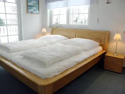 Ein Bett oder Betten in einem Zimmer der Unterkunft Fritz-Re uter-Straße Wohnung Sonnenuhr
