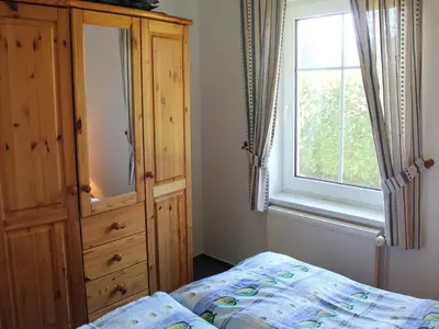 Ein Bett oder Betten in einem Zimmer der Unterkunft Ferienhaus mit Garten in Zingst