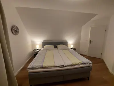 Ein Bett oder Betten in einem Zimmer der Unterkunft Neue Reihe 10 - moderne Ferienwohnung für 5 Personen