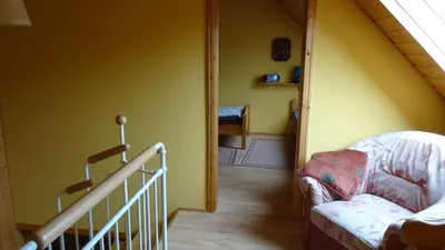 Ein Bett oder Betten in einem Zimmer der Unterkunft Ferienhaus Eulenhaus im urigen Garten