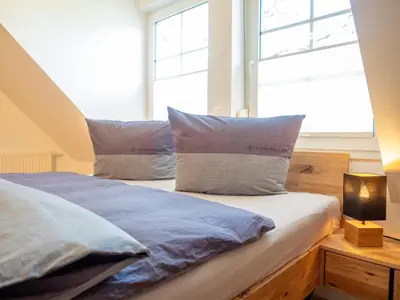 Ein Bett oder Betten in einem Zimmer der Unterkunft Dünenbrise