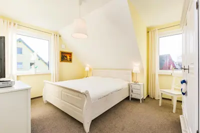 Ein Bett oder Betten in einem Zimmer der Unterkunft Ferienhaus - Deichweg 10
