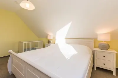 Ein Bett oder Betten in einem Zimmer der Unterkunft Ferienhaus - Deichweg 10
