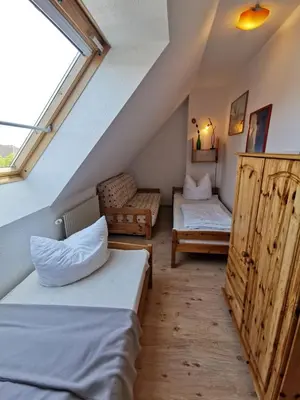 Ein Bett oder Betten in einem Zimmer der Unterkunft UNSERE PERLE MIT SAUNA UND BALKON in Zingst - Hund willkommen