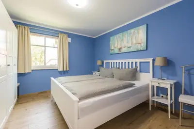 Ein Bett oder Betten in einem Zimmer der Unterkunft HMuschelsucher, Birkenstraße 7a, App 1