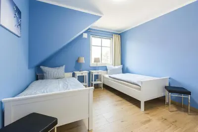 Ein Bett oder Betten in einem Zimmer der Unterkunft HMuschelsucher, Birkenstraße 7a, App 5