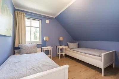 Ein Bett oder Betten in einem Zimmer der Unterkunft HMuschelsucher, Birkenstraße 7a, App 6