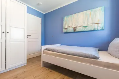 Ein Bett oder Betten in einem Zimmer der Unterkunft HMuschelsucher, Birkenstraße 7a, App 6