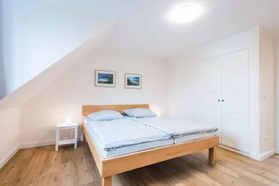 Ein Bett oder Betten in einem Zimmer der Unterkunft HMuschelsucher, Dünenstraße 44, App 2