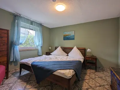 Ein Bett oder Betten in einem Zimmer der Unterkunft Dat smucke Reethus - EG