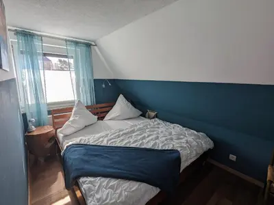 Ein Bett oder Betten in einem Zimmer der Unterkunft Dat smucke Reethus - OG