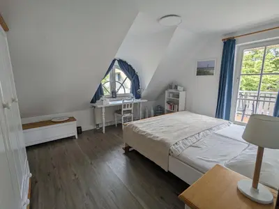 Ein Bett oder Betten in einem Zimmer der Unterkunft Boddenquartett - Kleine Brise