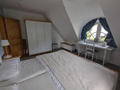 Ein Bett oder Betten in einem Zimmer der Unterkunft Boddenquartett - Kleine Brise
