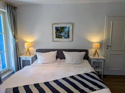 Ein Bett oder Betten in einem Zimmer der Unterkunft Boddenquartett - Sünnenkieker