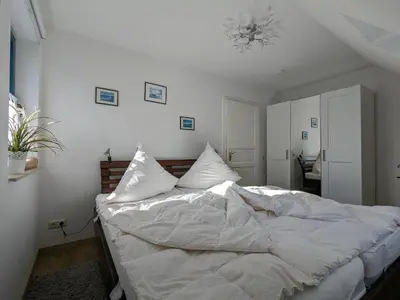 Ein Bett oder Betten in einem Zimmer der Unterkunft Lütt Stuuv