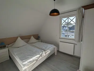 Ein Bett oder Betten in einem Zimmer der Unterkunft Dünenrose