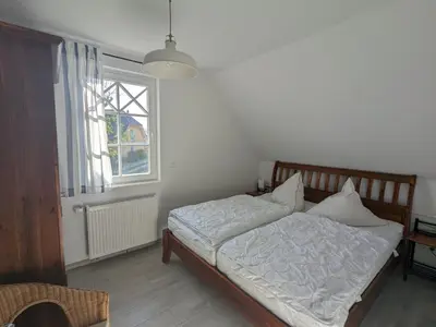 Ein Bett oder Betten in einem Zimmer der Unterkunft Dünenrose